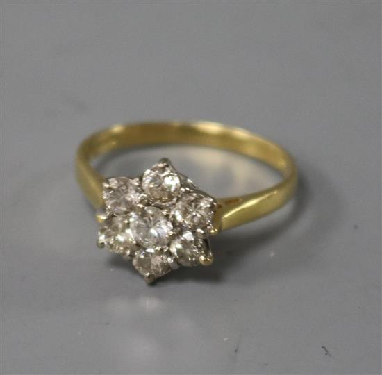 A modern 18ct gold and seven stone diamond cluster ring, size M.